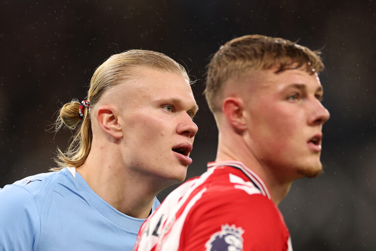 Erling Haaland of Man City looks on alongside Sunderland's Dan Ballard during the Premier League match between Manchester City and Sunderland at Etihad Stadium on December 06, 2025 in Manchester, England.
