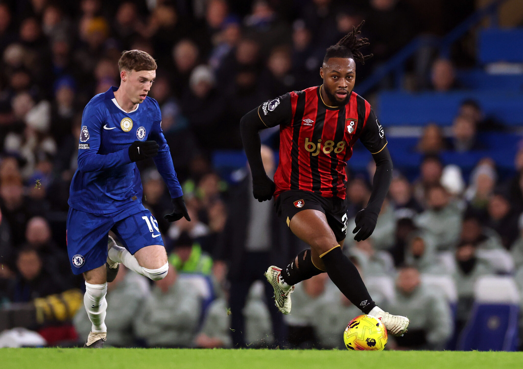Antoine Semenyo of AFC Bournemouth runs with the ball whilst under pressure from Cole Palmer of Chelsea during the Premier League match between Chelsea and Bournemouth at Stamford Bridge on December 30, 2025 in London, England.