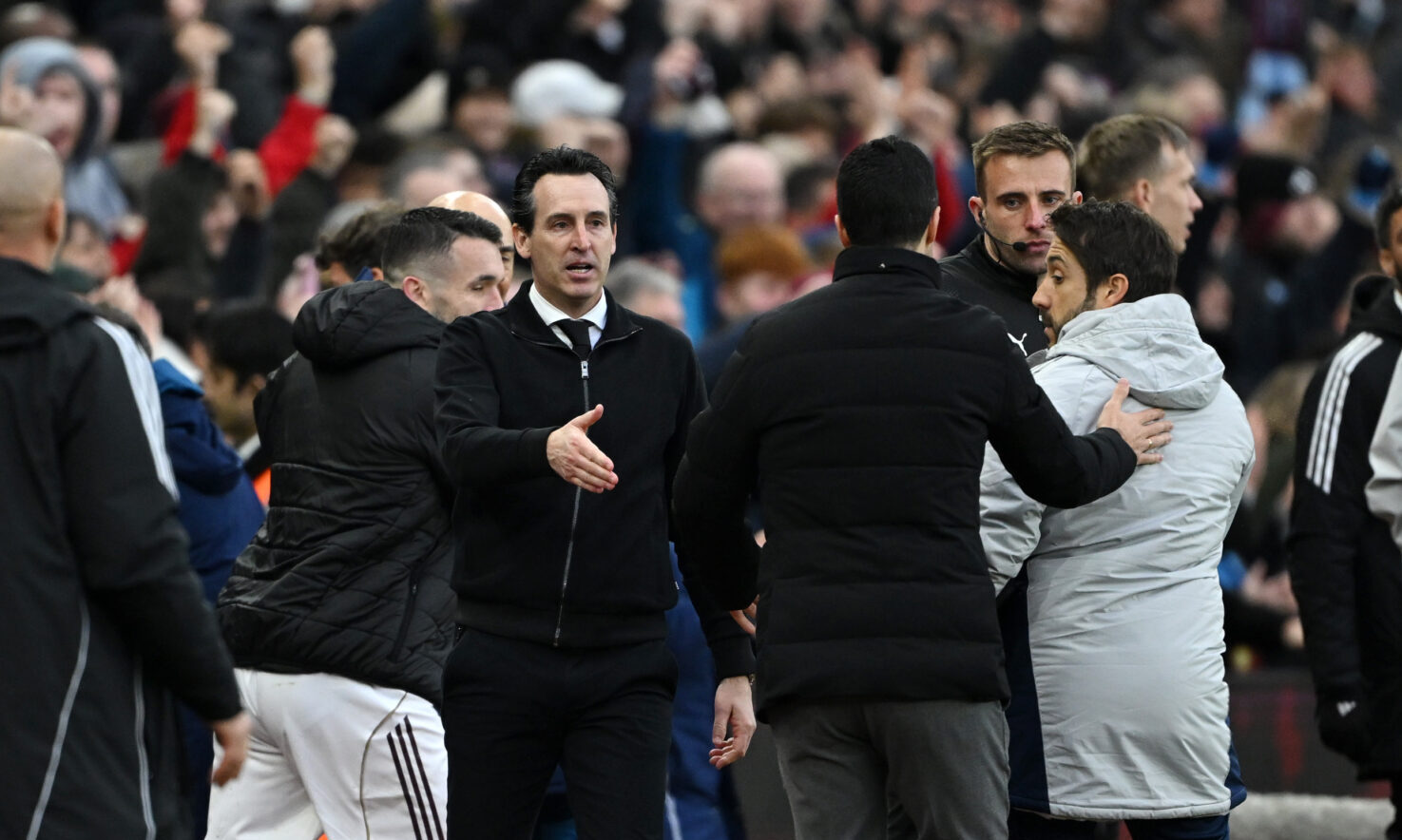 Unai Emery, Manager of Aston Villa, walks over to Mikel Arteta, Manager of Arsenal, to shake hands at the end of the game during the Premier League match between Aston Villa and Arsenal at Villa Park on December 06, 2025 in Birmingham, England.