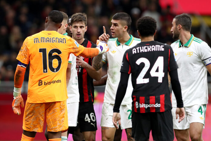 Mike Maignan of AC Milan clashes with Gianluca Mancini of AS Roma during the Serie A match between AC Milan and AS Roma at Giuseppe Meazza Stadium on November 02, 2025 in Milan, Italy.