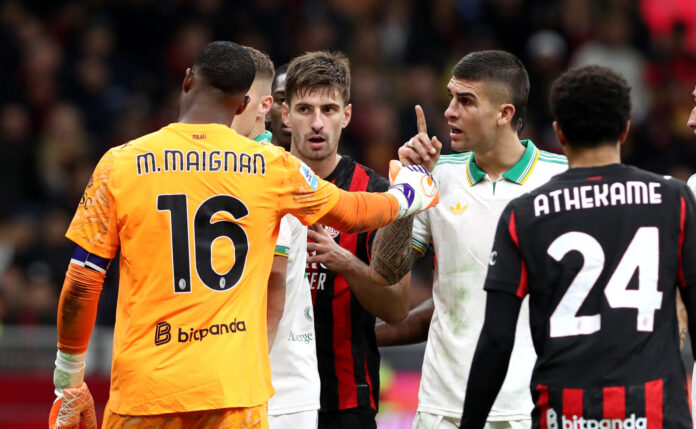 Mike Maignan of AC Milan clashes with Gianluca Mancini of AS Roma during the Serie A match between AC Milan and AS Roma at Giuseppe Meazza Stadium on November 02, 2025 in Milan, Italy.