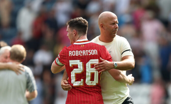 Arne Slot, Manager of Liverpool, hugs Andy Robertson after the pre-season friendly match between Preston North End and Liverpool at Deepdale on July 13, 2025 in Preston, England.