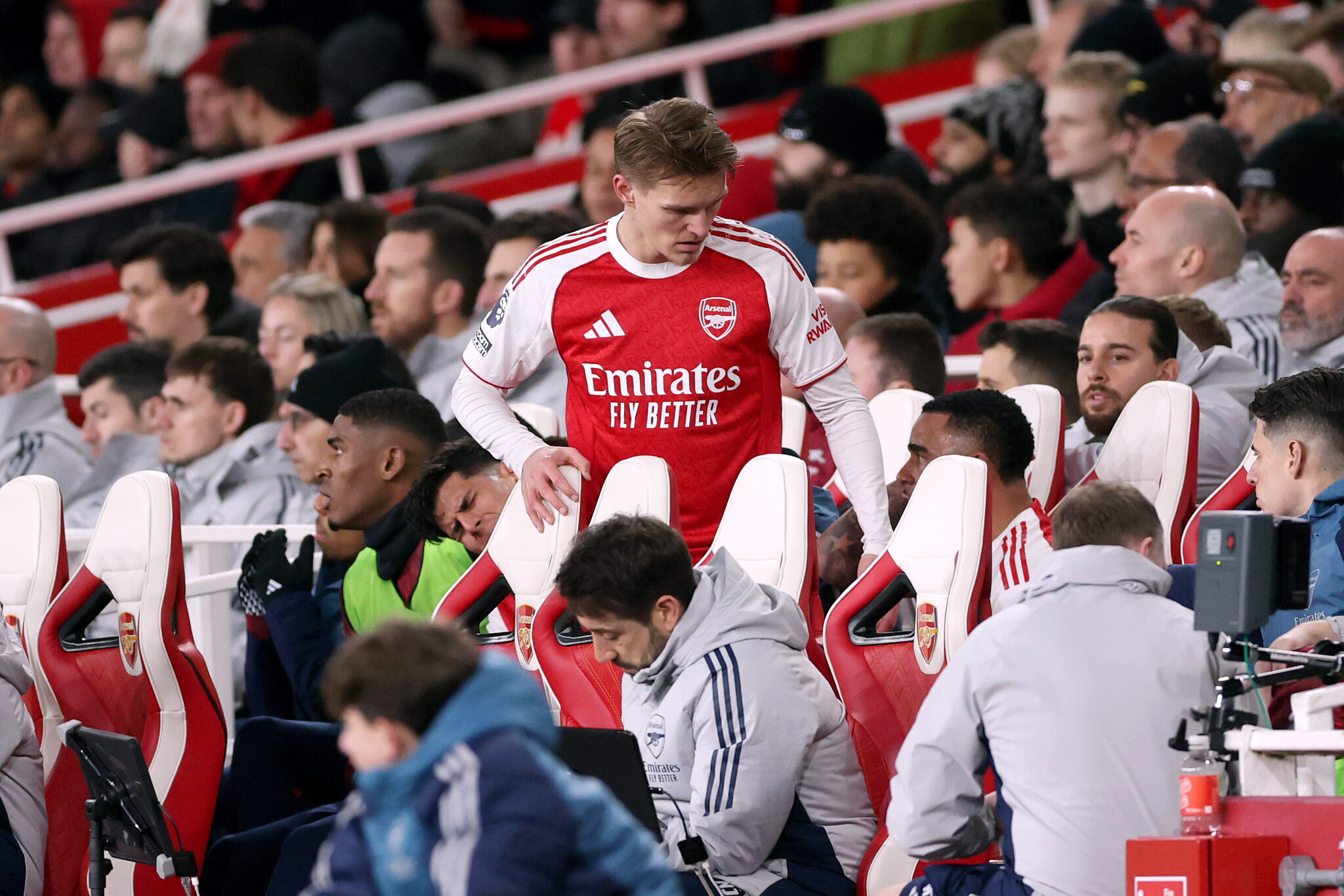 Martin Odegaard of Arsenal takes a seat in the dugout after being substituted off during the Premier League match between Arsenal and Manchester United at Emirates Stadium on January 25, 2026 in London, England.