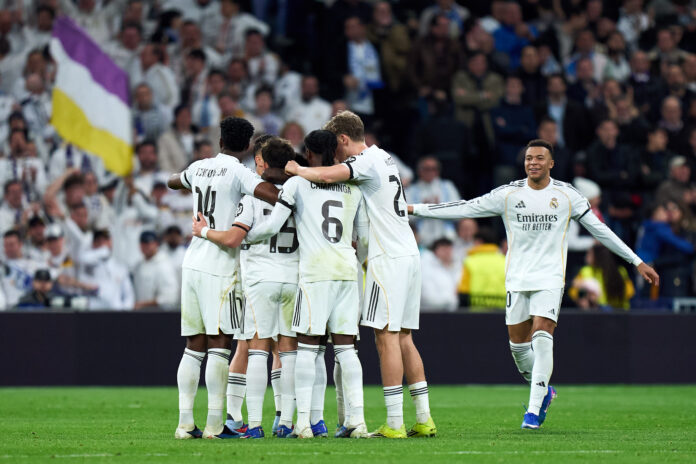 Vinicius Junior of Real Madrid celebrates with teammates their team's fifth goal during the UEFA Champions League 2025/26 League Phase MD7 match between Real Madrid C.F. and AS Monaco at Estadio Santiago Bernabeu on January 20, 2026 in Madrid, Spain.