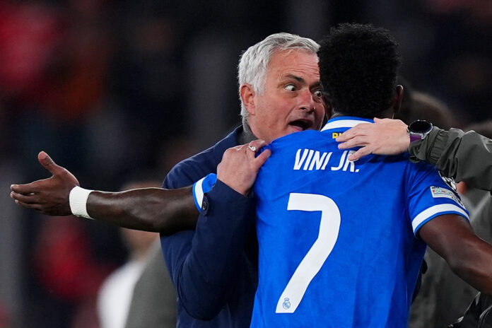 Jose Mourinho, Head Coach of Benfica, speaks to Vinicius Junior of Real Madrid during the UEFA Champions League 2025/26 League Knockout Play-off First Leg match between SL Benfica and Real Madrid C.F. at Estadio do SL Benfica on February 17, 2026 in Lisbon, Portugal.