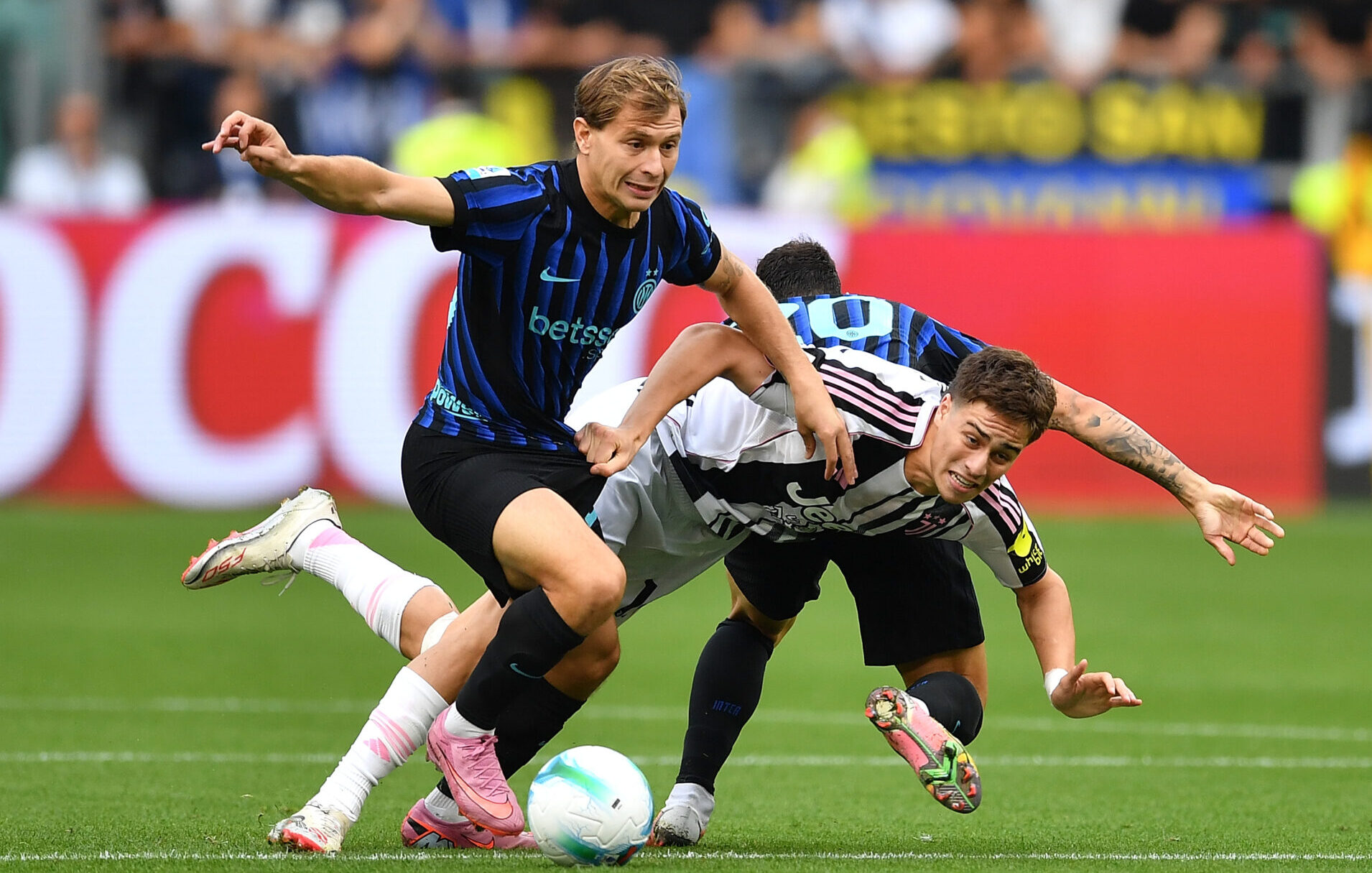 Kenan Yildiz of Juventus is tackled by Nicolo Barella and Hakan Calhanoglu of FC Internazionale during the Serie A match between Juventus FC and FC Internazionale on September 13, 2025 in Turin, Italy.