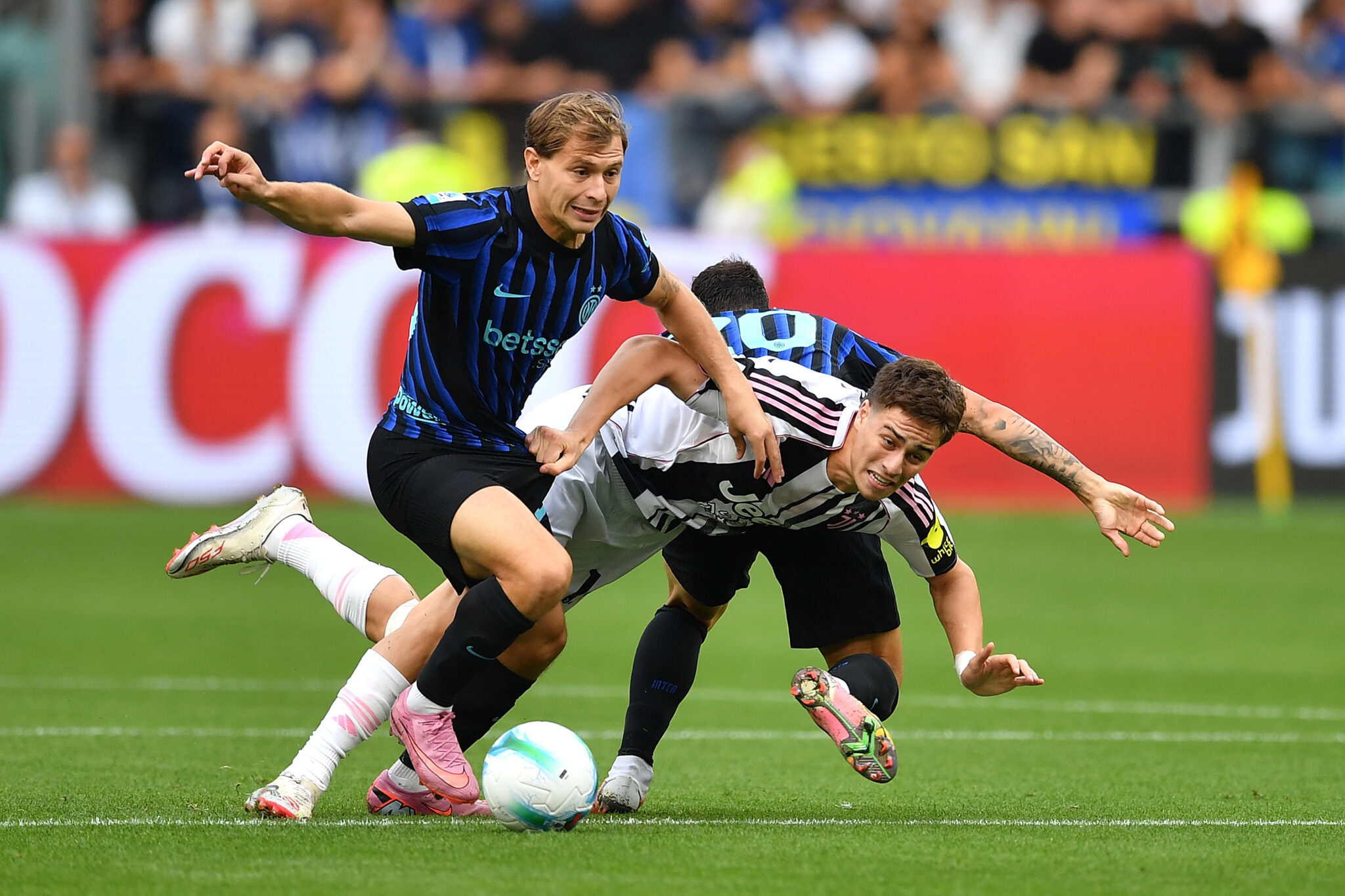 Kenan Yildiz of Juventus is tackled by Nicolo Barella and Hakan Calhanoglu of FC Internazionale during the Serie A match between Juventus FC and FC Internazionale on September 13, 2025 in Turin, Italy.