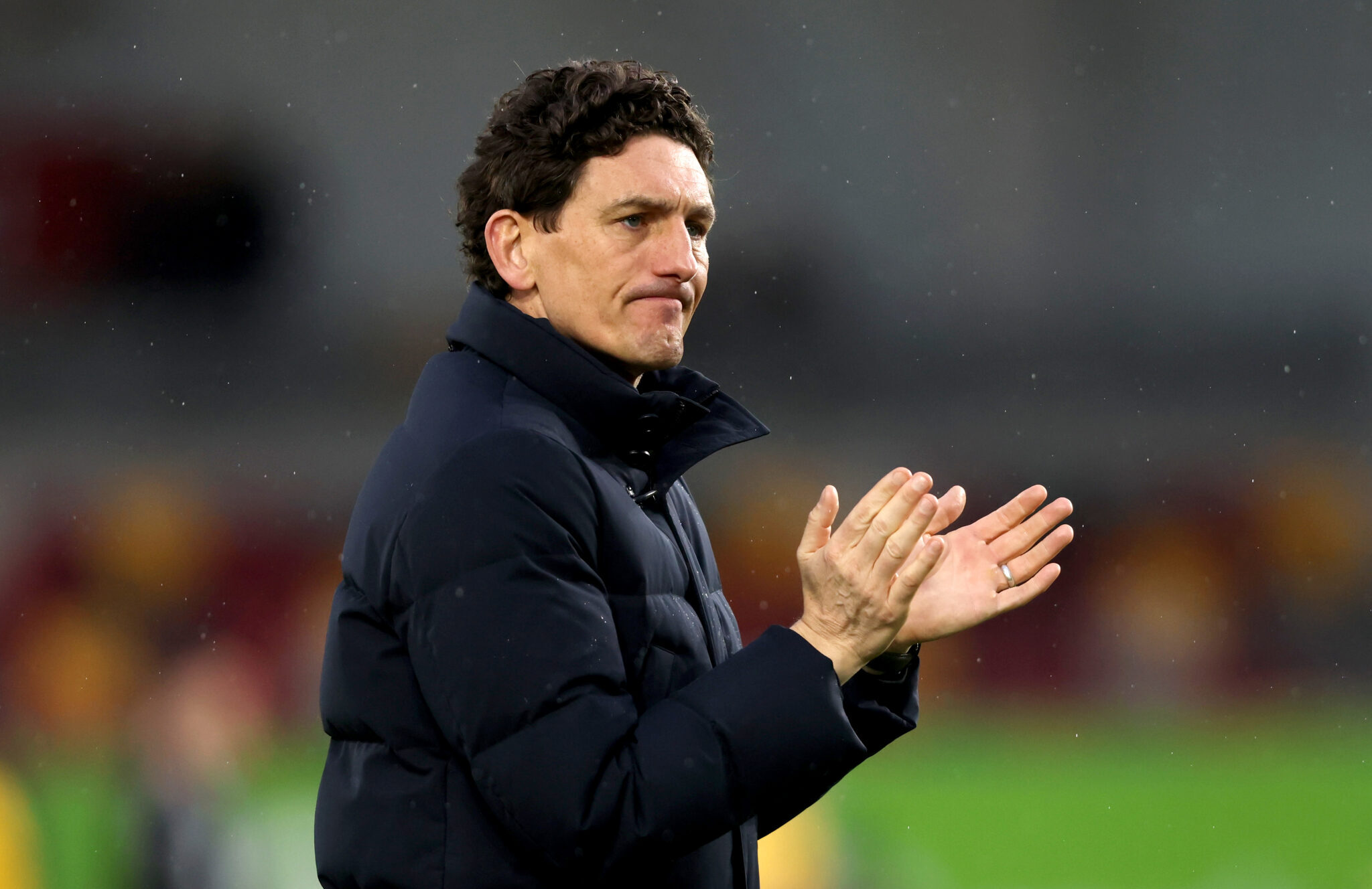 Keith Andrews, Manager of Brentford, applauds the fans following the team's defeat in the Premier League match between Brentford and Brighton & Hove Albion at Gtech Community Stadium on February 21, 2026 in Brentford, England.