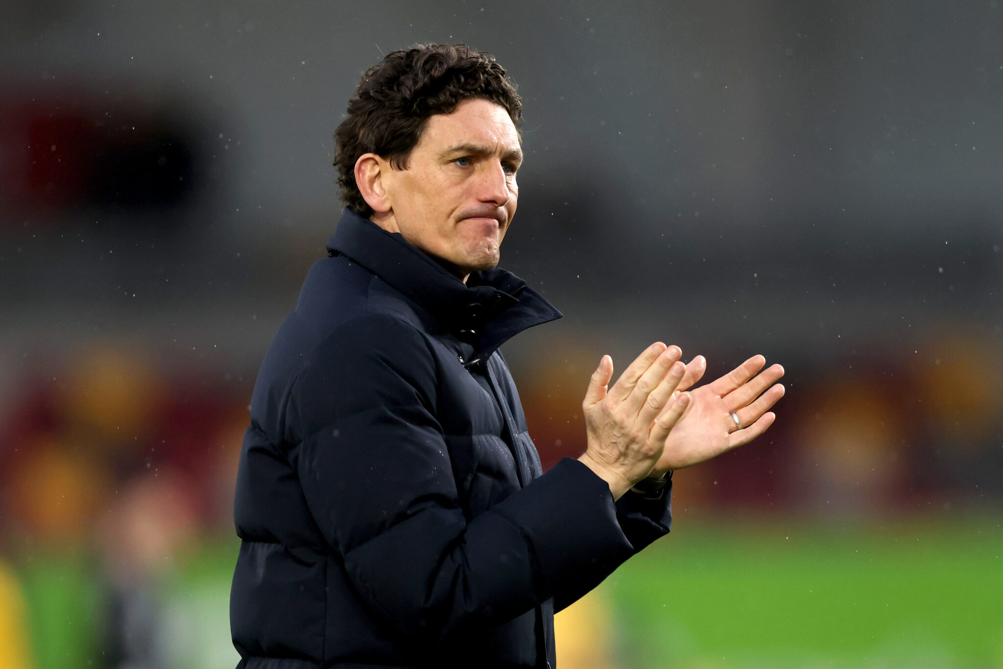 Keith Andrews, Manager of Brentford, applauds the fans following the team's defeat in the Premier League match between Brentford and Brighton & Hove Albion at Gtech Community Stadium on February 21, 2026 in Brentford, England.