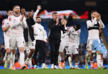 Salford City take ‘immense pride’ from Man City defeat in FA Cup Karl Robinson, Manager of Salford City, acknowledges the fans with his players after the Emirates FA Cup Fourth Round match between Manchester City and Salford City at Etihad Stadium on February 14, 2026 in Manchester, England.