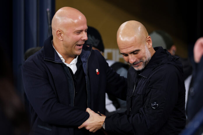 Arne Slot, Manager of Liverpool, and Pep Guardiola, Manager of Manchester City, interact prior to the Premier League match between Manchester City and Liverpool at Etihad Stadium on November 09, 2025 in Manchester, England.