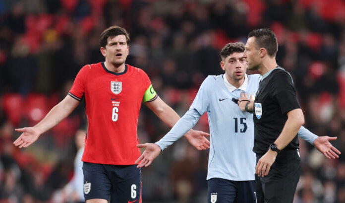 Harry Maguire of England and Federico Valverde of Uruguay react towards referee Sven Jablonski during the international friendly match between England and Uruguay at Wembley Stadium on March 27, 2026 in London, England.
