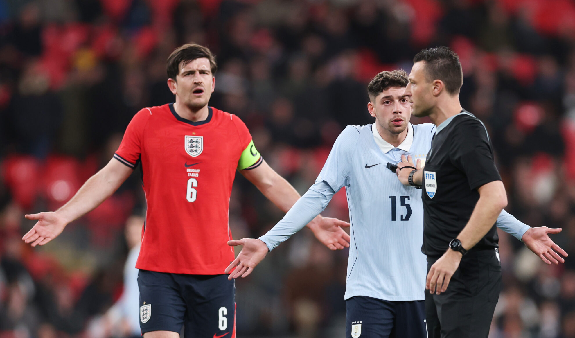 Harry Maguire of England and Federico Valverde of Uruguay react towards referee Sven Jablonski during the international friendly match between England and Uruguay at Wembley Stadium on March 27, 2026 in London, England.