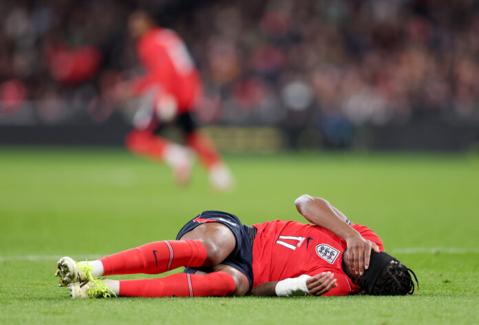 Arsenal player Noni Madueke reacts on the floor, which results in him being substituted due to a injury during the international friendly match between England and Uruguay at Wembley Stadium on March 27, 2026 in London, England.