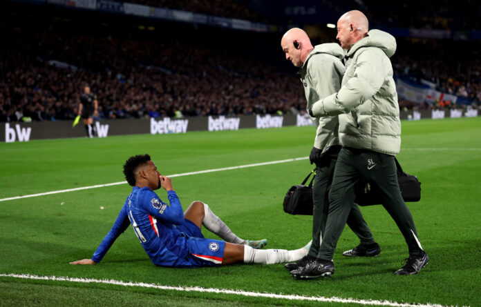 Estevao of Chelsea reacts with an injury during the Premier League match between Chelsea and Manchester United at Stamford Bridge on April 18, 2026 in London, England.