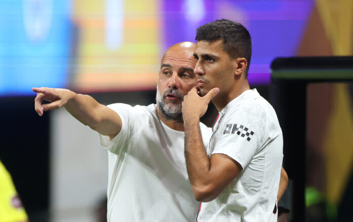 Pep Guardiola, Head Coach of Manchester City, gives Rodri #16 instructions during the FIFA Club World Cup 2025 group G match between Man City FC and Al Ain FC at Mercedes-Benz Stadium on June 22, 2025 in Atlanta, Georgia.