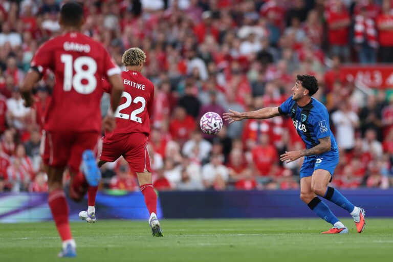 Marcos Senesi of AFC Bournemouth handles the ball denying Liverpool's Hugo Ekitike a run on goal only to receive a yellow card during the Premier League match between Liverpool and Bournemouth at Anfield on August 15, 2025 in Liverpool, England.
