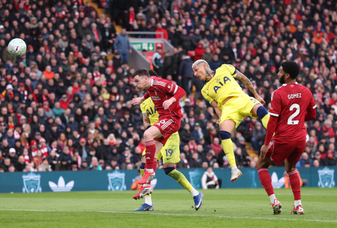 Spurs forward Richarlison has a chance with a header whilst under pressure from Andy Robertson of Liverpool during the Premier League match between Liverpool and Tottenham Hotspur at Anfield on March 15, 2026 in Liverpool, England.