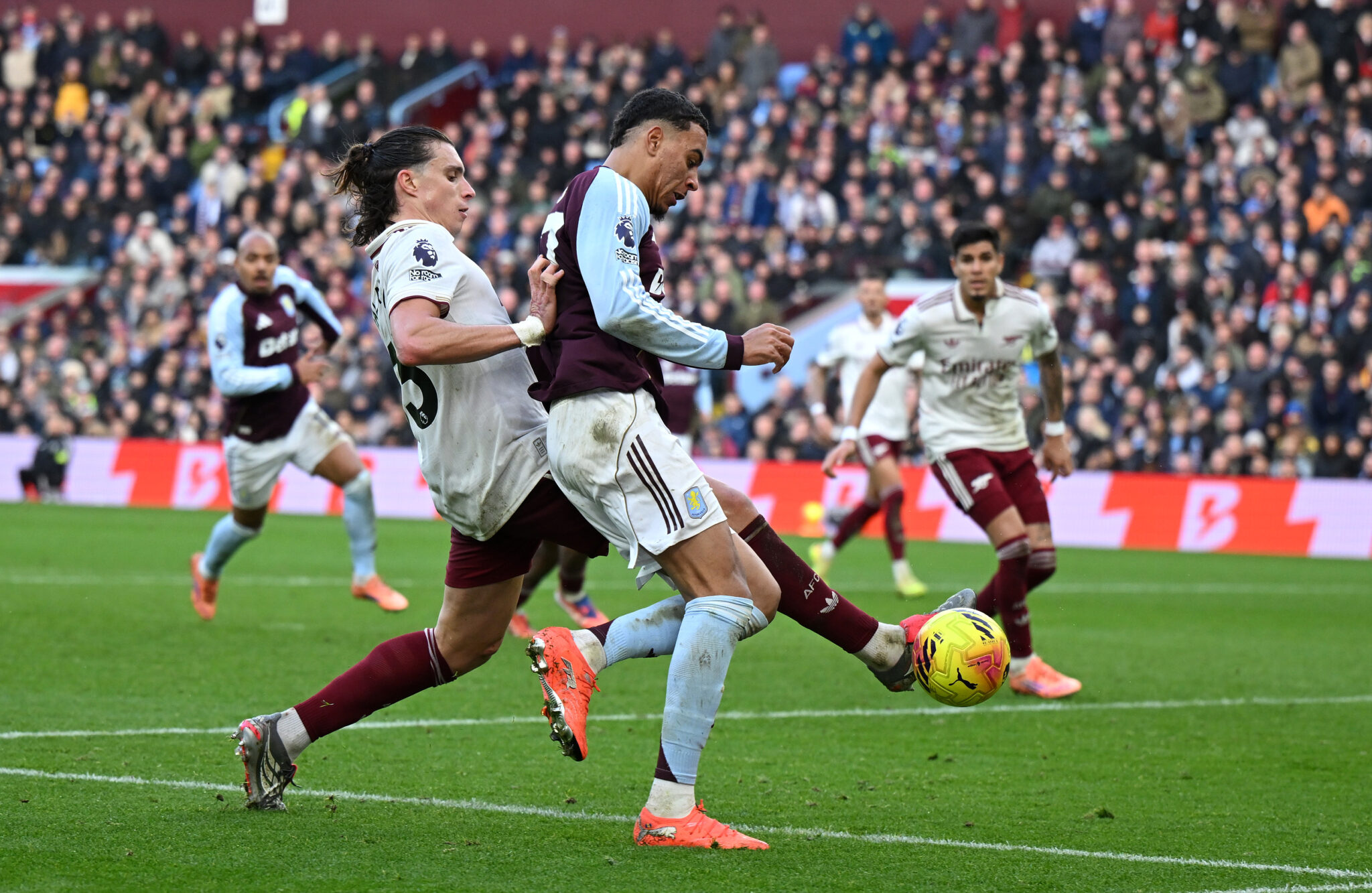 Morgan Rogers of Aston Villa is challenged by Riccardo Calafiori of Arsenal during the Premier League match between Aston Villa and Arsenal at Villa Park on December 06, 2025 in Birmingham, England.
