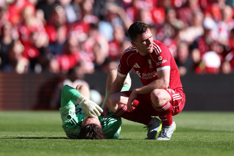 Freddie Woodman of Liverpool reacts with teammate Andy Robertson after picking up an injury during the Premier League match between Liverpool and Crystal Palace at Anfield on April 25, 2026 in Liverpool, England.