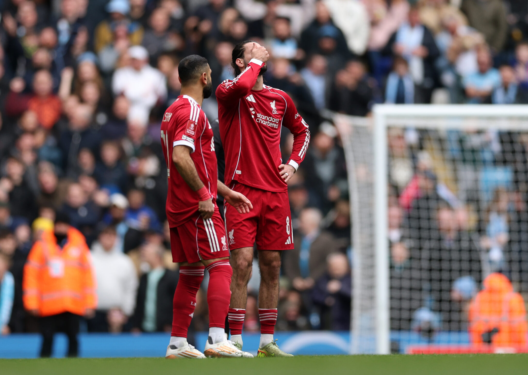 Mo Salah and Dominik Szoboszlai of Liverpool react after conceding the third goal, scored by Antoine Semenyo of Manchester City during the Emirates FA Cup Quarter Final match between Manchester City and Liverpool at Etihad Stadium on April 04, 2026 in Manchester, England.