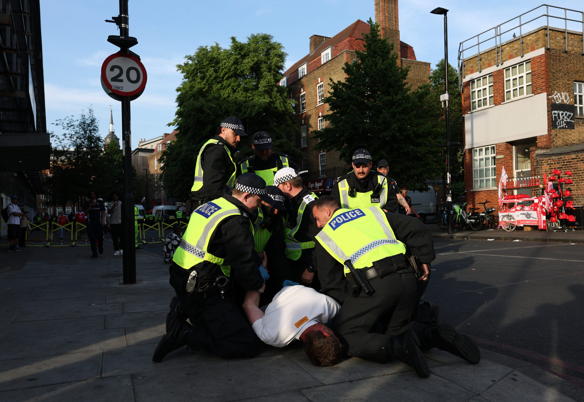 Arsenal fan is arrested as fans gather outside the Emirates stadium during the UEFA Champions League Final between PSG and Arsenal on May 30, 2026 in London, England.