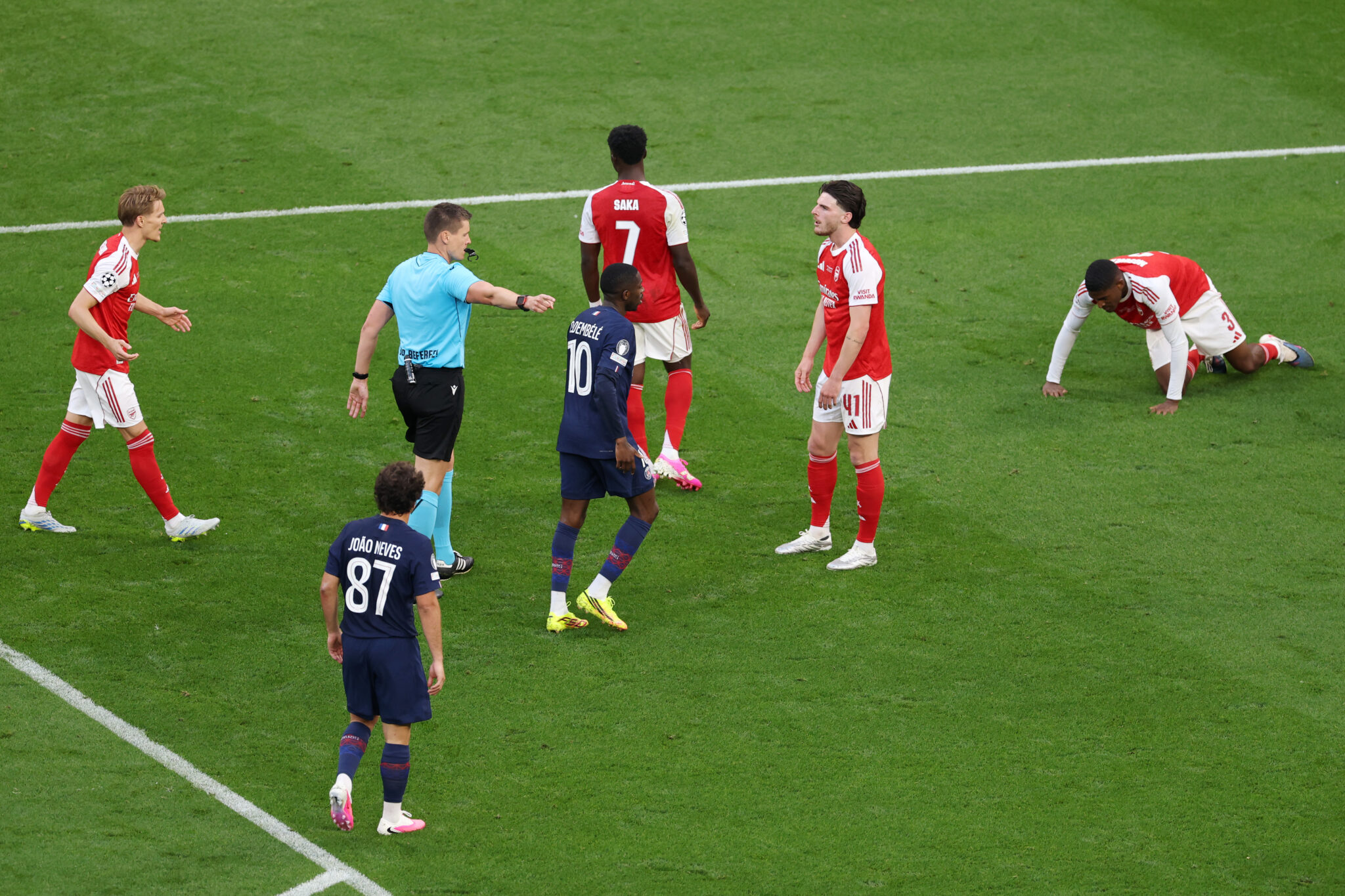 Referee Daniel Siebert points to the penalty spot as Declan Rice of Arsenal reacts, after Cristhian Mosquera of Arsenal fouled Khvicha Kvaratskhelia of PSG (not pictured), during the UEFA Champions League Final 2026 match between Paris Saint-Germain and Arsenal FC at Puskas Arena on May 30, 2026 in Budapest, Hungary.