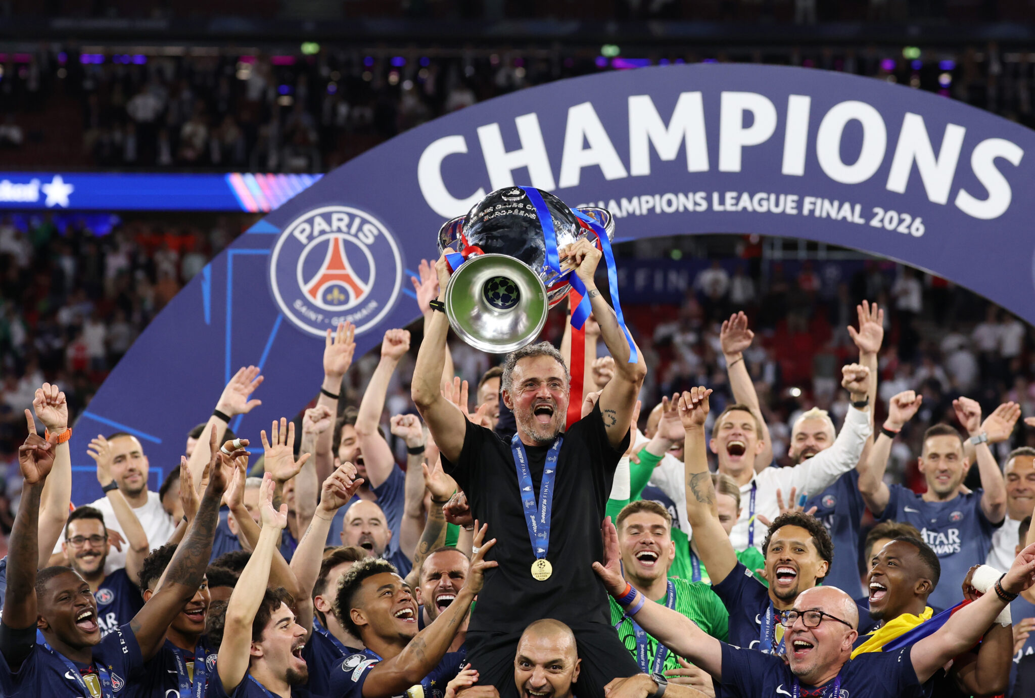 Luis Enrique, Head Coach of Paris Saint-Germain, lifts the UEFA Champions League trophy after his team's victory in the UEFA Champions League Final 2026 match between Paris Saint-Germain and Arsenal FC at Puskas Arena on May 30, 2026 in Budapest, Hungary.