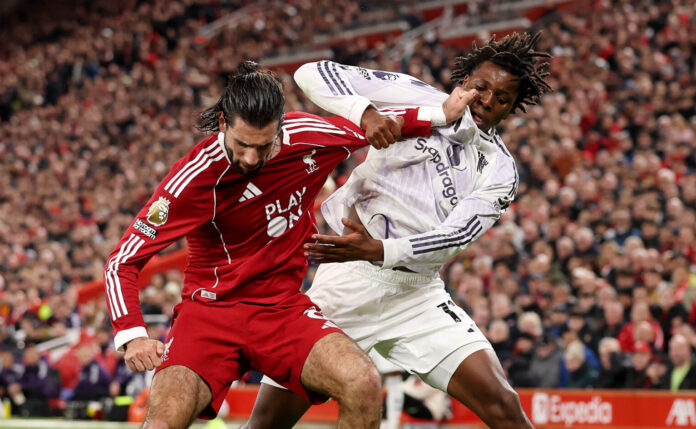 Man Utd vs Liverpool combined XI - Dominik Szoboszlai of Liverpool is challenged by Patrick Dorgu of Manchester United during the Premier League match between Liverpool and Manchester United at Anfield on October 19, 2025 in Liverpool, England.