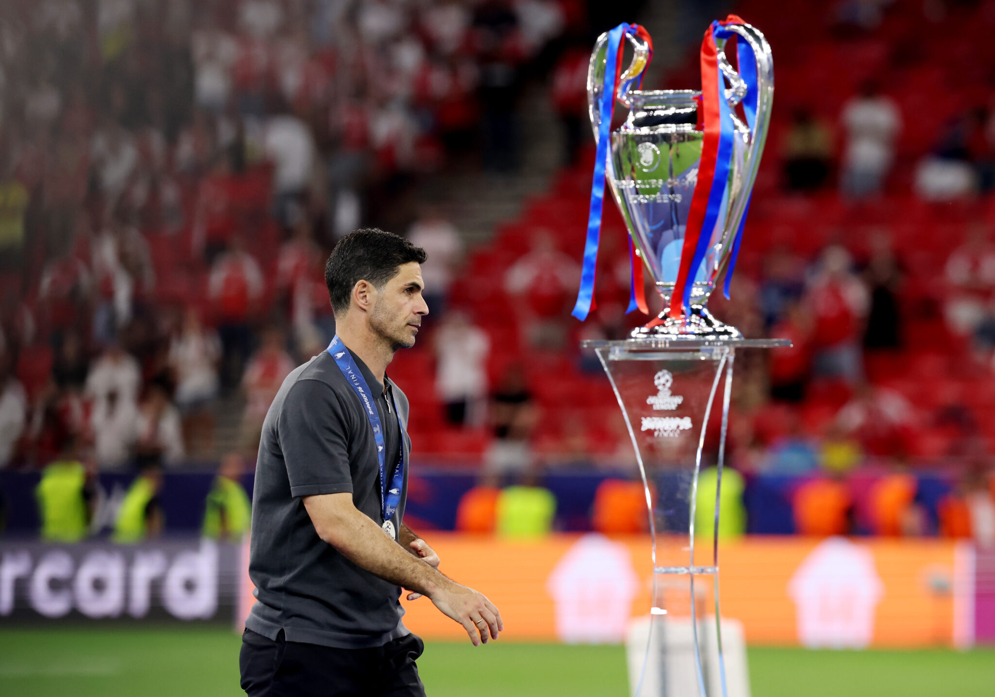 Arsenal manager Mikel Arteta walks past the UEFA Champions League trophy following the UEFA Champions League Final 2026 match between Paris Saint-Germain and Arsenal FC at Puskas Arena on May 30, 2026 in Budapest, Hungary.