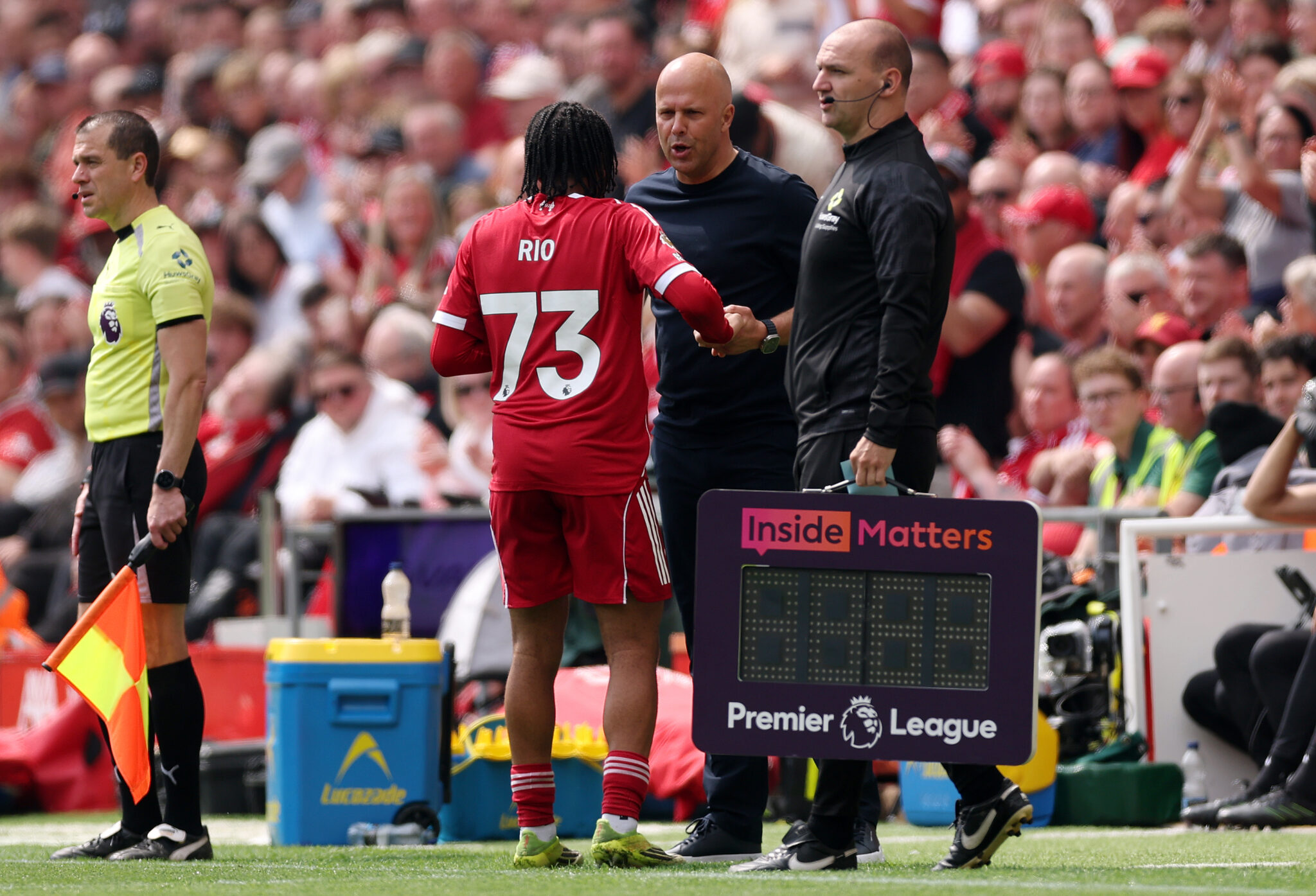 Rio Ngumoha of Liverpool interacts with Arne Slot, Manager of Liverpool, after he leaves the pitch during the Premier League match between Liverpool and Chelsea at Anfield on May 09, 2026 in Liverpool, England.