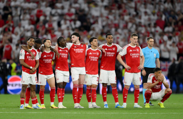 Arsenal players Jurrien Timber, Noni Madueke, Gabriel Martinelli, Eberechi Eze, Declan Rice, Martin Zubimendi, Gabriel, Viktor Gyokeres and William Saliba of Arsenal look on as they wait for penalties during the UEFA Champions League Final 2026 match between Paris Saint-Germain and Arsenal FC at Puskas Arena on May 30, 2026 in Budapest, Hungary.