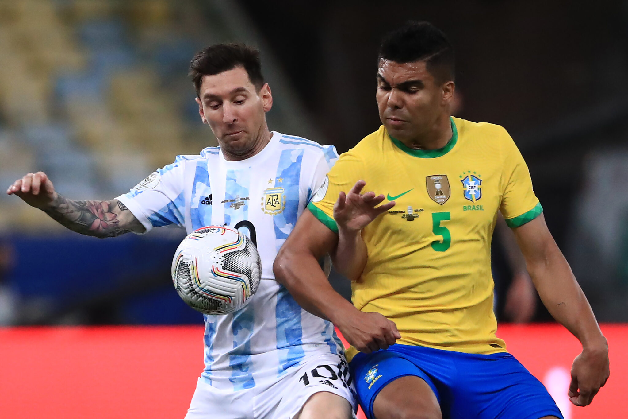 Casemiro of Brazil and Lionel Messi of Argentina fight for the ball during the final of Copa America Brazil 2021 between Brazil and Argentina at Maracana Stadium on July 10, 2021 in Rio de Janeiro, Brazil.