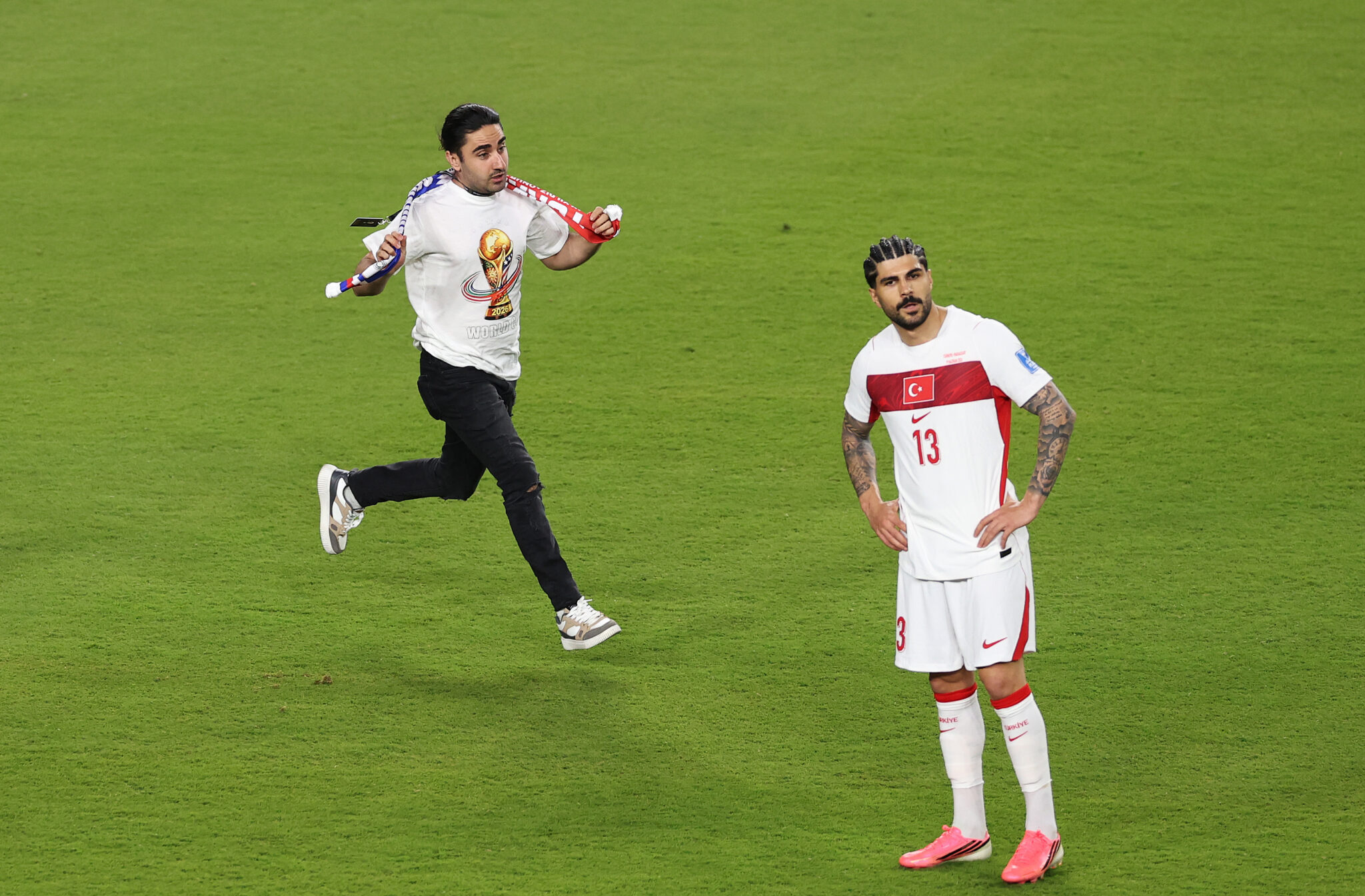 World Cup - Eren Elmali #13 of Turkiye looks on as a pitch invader approaches during the FIFA World Cup 2026 Group D match between Türkiye and Paraguay at San Francisco Bay Area Stadium on June 19, 2026 in Santa Clara, California.
