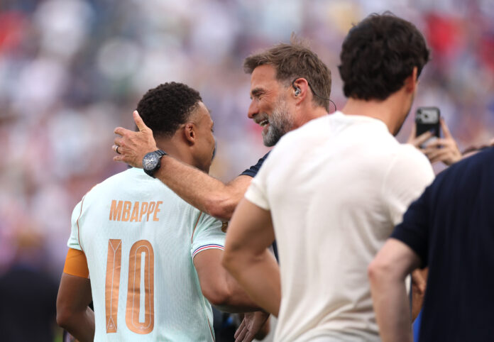 Kylian Mbappe #10 of France is congratulated by former Liverpool manager Jurgen Klopp after the team's 2-0 victory in during the FIFA World Cup 2026 Quarter Final match between France and Morocco at Boston Stadium on July 09, 2026 in Foxborough, Massachusetts.